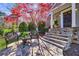 Cozy stone patio with seating and landscaped front yard at 1287 University Ne Dr, Atlanta, GA 30306
