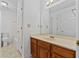 Bathroom with wood vanity, large mirror, tub-shower combo and tile flooring at 2209 N Forest Trl, Dunwoody, GA 30338
