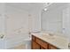 Bathroom featuring a tub-shower combo, wood vanity, and neutral colored sink at 2209 N Forest Trl, Dunwoody, GA 30338