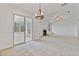 The dining room has carpet flooring, white walls, a light fixture, and sliding glass doors leading to a sunroom at 2209 N Forest Trl, Dunwoody, GA 30338
