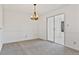 This dining room features carpet flooring, white walls with a light fixture, and sliding glass doors at 2209 N Forest Trl, Dunwoody, GA 30338