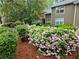 Beautiful landscaping surrounding the house with blooming pink flowers, lush greenery and manicured bushes at 2209 N Forest Trl, Dunwoody, GA 30338