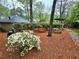 Common ground with picnic tables, benches, grill and white flowering bush on a bed of pine straw at 2209 N Forest Trl, Dunwoody, GA 30338