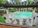 Outdoor pool surrounded by lounge chairs and wooden pergola, offering a relaxing community amenity at 2209 N Forest Trl, Dunwoody, GA 30338