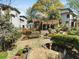Well-manicured backyard featuring a wooden deck, stone patio and lush landscaping for outdoor enjoyment at 573 Amsterdam Ne Ave, Atlanta, GA 30306