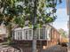 Exterior home view featuring brick accents, a well-manicured yard, and patio seating at 573 Amsterdam Ne Ave, Atlanta, GA 30306