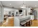 Open-concept kitchen island with seating next to the living room, featuring hardwood floors at 573 Amsterdam Ne Ave, Atlanta, GA 30306
