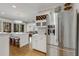 Open kitchen boasts a stainless steel refrigerator, wine rack, and adjoining bar with seating at 573 Amsterdam Ne Ave, Atlanta, GA 30306