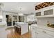 Kitchen showcases an island with seating, stainless appliances, and seamless flow to the living area at 573 Amsterdam Ne Ave, Atlanta, GA 30306
