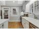 Bright kitchen featuring white cabinetry, marble countertops, hardwood floors, and stainless steel appliances at 573 Amsterdam Ne Ave, Atlanta, GA 30306