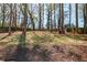 Wooded backyard with mature trees and a wooden fence at 91 Griggs Sw St, Marietta, GA 30064