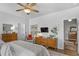 Bright bedroom features wood floors, ceiling fan, dresser, and a flatscreen TV at 91 Griggs Sw St, Marietta, GA 30064