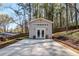 A detached outbuilding with neutral siding and double doors, complemented by a concrete driveway at 91 Griggs Sw St, Marietta, GA 30064