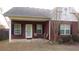 Relaxing back porch with brick columns, seating, and access to the home's interior at 238 Valley Hill Road Rd, Riverdale, GA 30274