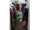 A walk-in closet with clothes hanging on rods and shelving above for storage at 238 Valley Hill Road Rd, Riverdale, GA 30274