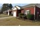 A charming one-story red brick house with a well-manicured lawn and an attached garage at 238 Valley Hill Road Rd, Riverdale, GA 30274