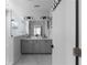 Modern bathroom featuring a double vanity with gray cabinets and a glass-enclosed shower at 2736 Bell Se Dr, Smyrna, GA 30080
