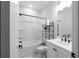Bathroom featuring white vanity, black hardware, white shower/tub combo with curtain and added storage at 2736 Bell Se Dr, Smyrna, GA 30080