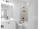 Modern bathroom featuring a white vanity, toilet, and tub with a shower and white tile at 2736 Bell Se Dr, Smyrna, GA 30080