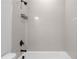 Close-up of a bathtub with white tile walls and black shower fixtures at 2736 Bell Se Dr, Smyrna, GA 30080