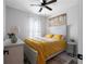 Cozy bedroom with neutral walls, yellow bedding, white furniture, and a ceiling fan at 2736 Bell Se Dr, Smyrna, GA 30080