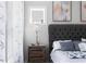 Bright bedroom featuring a tufted headboard, stylish bedside table, and soft natural light from the window at 2736 Bell Se Dr, Smyrna, GA 30080