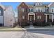 Beautiful townhome features a brick exterior, black shutters, and a fenced front yard, perfect for curb appeal at 2736 Bell Se Dr, Smyrna, GA 30080