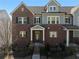 Elegant townhome features brick and gray siding, a covered entrance, and a well-manicured front yard at 2736 Bell Se Dr, Smyrna, GA 30080