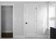Bright hallway with a window and a modern black cabinet and white doors that lead to different rooms at 2736 Bell Se Dr, Smyrna, GA 30080