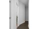 Hallway with dark hardwood flooring and white trim and a view into another room at 2736 Bell Se Dr, Smyrna, GA 30080