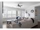 Bright living room features large windows, ceiling fan, and a comfortable couch with decorative pillows and throw at 2736 Bell Se Dr, Smyrna, GA 30080