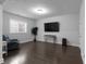 Finished basement with a large TV, hardwood floors, and a cozy seating area for relaxation at 2736 Bell Se Dr, Smyrna, GA 30080