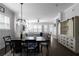Bright, open-plan living and dining area with hardwood floors and a modern farmhouse cabinet at 2736 Bell Se Dr, Smyrna, GA 30080