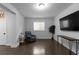 Bright, spacious living room with dark wood floors, recliner, console table, and plenty of natural light at 2736 Bell Se Dr, Smyrna, GA 30080