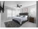 Bedroom featuring a large, tufted headboard bed, a plush rug, and large windows at 2736 Bell Se Dr, Smyrna, GA 30080