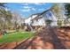 Wide backyard view with a two-story home and deck featuring steps and lush green grass at 1135 Parkview Sw Way, Lilburn, GA 30047