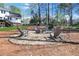 Backyard with a circular firepit, surrounded by Adirondack chairs, in a serene wooded setting at 1135 Parkview Sw Way, Lilburn, GA 30047