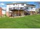 Two story backyard with a brick and white exterior featuring a staircase and freshly cut green grass at 1135 Parkview Sw Way, Lilburn, GA 30047