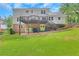Backyard view with a deck, grassy area, and well-maintained landscaping at 1135 Parkview Sw Way, Lilburn, GA 30047