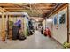 An unfinished basement with exposed ceiling, filled with belongings and storage with white walkout doors at 1135 Parkview Sw Way, Lilburn, GA 30047