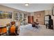 Finished basement with a drum set, brick fireplace, natural light, and concrete flooring at 1135 Parkview Sw Way, Lilburn, GA 30047