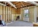 Unfinished basement with exposed pipes and framing, featuring a single window, perfect for renovations at 1135 Parkview Sw Way, Lilburn, GA 30047