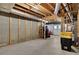 Unfinished basement space with visible framing, concrete floor, and access to the outside at 1135 Parkview Sw Way, Lilburn, GA 30047