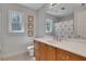 Bathroom featuring a double vanity, bright natural lighting and a rainbow shower curtain at 1135 Parkview Sw Way, Lilburn, GA 30047