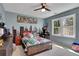 Bright bedroom with a modern ceiling fan, a wall mural and natural lighting from the windows at 1135 Parkview Sw Way, Lilburn, GA 30047