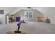 Bonus room with natural light features ample space for exercise and play, complemented by hardwood floors at 1135 Parkview Sw Way, Lilburn, GA 30047