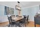 Dining room with wooden table set and modern chandelier at 1135 Parkview Sw Way, Lilburn, GA 30047