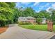 Attractive two-story brick home with a spacious, well-maintained lawn and long driveway at 1135 Parkview Sw Way, Lilburn, GA 30047
