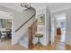 Bright foyer with hardwood floors, staircase and white trim accents at 1135 Parkview Sw Way, Lilburn, GA 30047