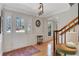 Inviting foyer with hardwood floors, white wainscoting, and staircase at 1135 Parkview Sw Way, Lilburn, GA 30047